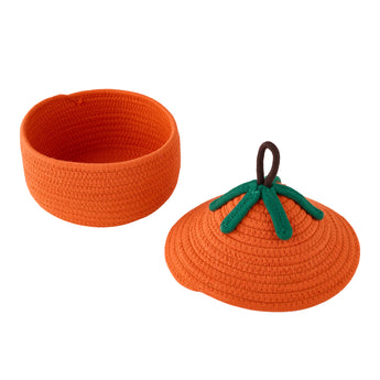 Orange crocheted pumpkin basket with green stem top and open bowl interior