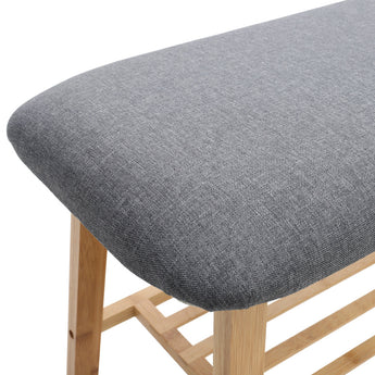 Gray upholstered bench seat on light bamboo frame with open two-tier slatted base
