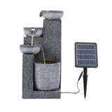 Outdoor solar fountain decor set with dark gray stacked basins and separate solar panel.