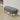 Grey upholstered bench with rounded seat and tapered wooden legs