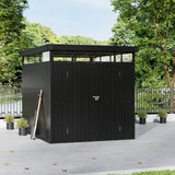 Metal storage shed with flat roof, black corrugated panels, closed double doors