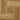Peel-and-stick vinyl floor tile with small water droplets on wood pattern.