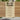 Wooden garden gate with horizontal plank panel and black latch hardware, light timber.