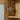 Wall cabinet mirror door hinge hardware on wood grain frame with shelf openings