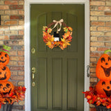 Autumn Halloween wreath on a front door, with maple leaves, pumpkins, and a hanging bell