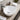 White ceramic countertop basin with oval bowl and round pop-up drain opening