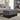 Gray button-tufted upholstered bench with padded top and dark carved legs