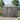 Metal storage shed with apex roof and lockable double doors, corrugated steel walls