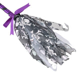 Close-up of purple-striped Halloween wand with silver skeleton-print tulle pouch