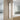 Silver stainless steel shower tower panel: shower head, hose, and control knobs