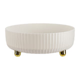White round turntable tray with ribbed sides and gold base feet