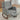 Grey upholstered rocking chair with extended footrest and front storage pocket