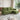 Green sofa with chaise, rivet-trimmed side panel and deep seat cushions