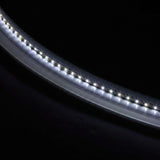 Oval frameless bathroom mirror with built-in LED strip, close-up of glowing edge