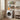 Black 2-tier over-washer storage rack with shelves and bottles above a front-load washer