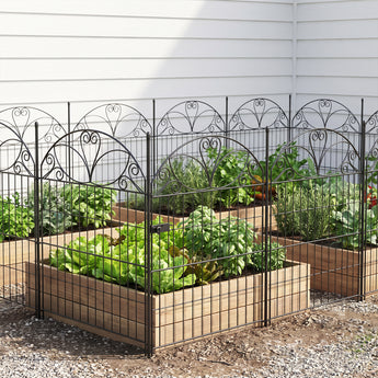 Black metal decorative garden fence with gate and arched scroll-top panels