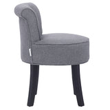 Grey upholstered vanity stool with rounded seat, tufted back detail, black wooden legs