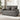 Grey two-seat sofa bed with two back pillows, squared arms, and firm seat
