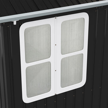 White window panel with four frosted panes on black metal shed wall
