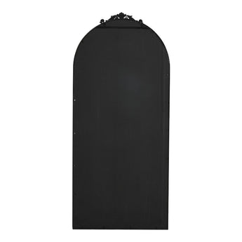 Back view of black arched freestanding mirror with decorative top