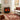Freestanding electric fireplace heater with realistic flame behind dark glass doors
