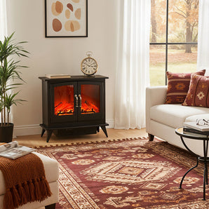 Freestanding electric fireplace heater with realistic flame behind dark glass doors