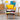 Velvet wingback armchair with yellow cushion and patchwork back, plus footstool