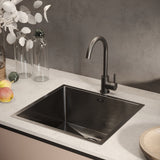 Black single-bowl stainless sink with undermount-style rim and integrated strainer