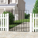 Black metal garden gate with decorative scrollwork and vertical bars