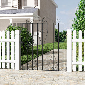 Black metal garden gate with decorative scrollwork and vertical bars