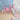 Pink toddler swing and slide set with basketball hoop and orange ball on floor