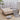 Button-tufted velvet ottoman footstool with neutral upholstery and gourd-shaped wood legs