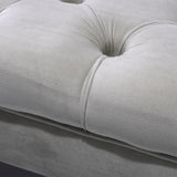 Velvet ottoman footstool upholstery close-up with button tufting and padded seams