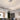 Tiered LED hanging ceiling light with three glowing white circular ring shades and cables