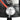 Close-up of round gas regulator on black ceramic gas heater with orange hose