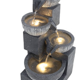4-tier fountain with warm LED glow and cascading water over gray bowls
