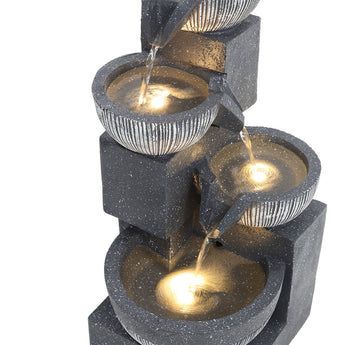 4-tier fountain with warm LED glow and cascading water over gray bowls