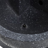 Pump/connector port on gray fountain base with textured stone surface