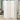 White woven rattan folding room divider in a room, 4 panels with rounded tops