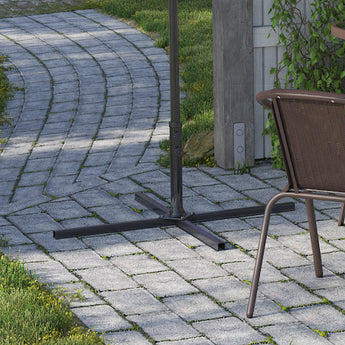 Cantilever parasol with black cross base on stone paving