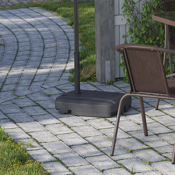 Light grey cantilever parasol with square weighted base near garden seating