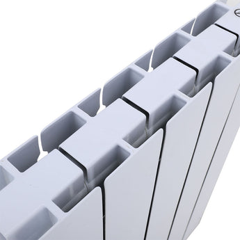 Wall mounted electric heater close-up of white vertical fins with dark edge lines