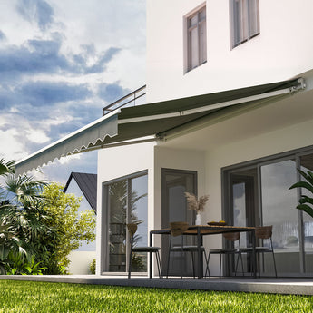 Grey manual retractable patio awning mounted over a patio door and windows