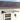 Black outdoor flat rain shelter with clear canopy and wall-mounted brackets