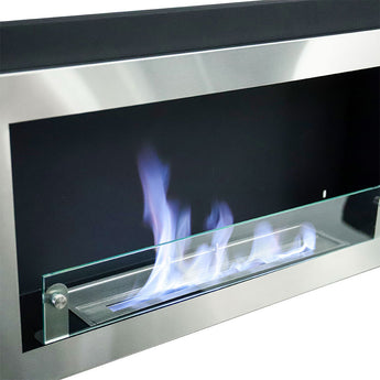 Close-up of inset bioethanol fireplace burner with blue flames behind glass