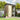 Metal garden tool storage shed with rooftop, open double doors, shelving inside
