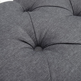 Close-up of tufted seat cushion sections on gray storage bench ottoman