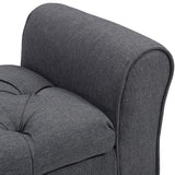 Close-up of gray padded arm and seat cushion on button-tufted storage bench