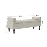Beige linen upholstered storage bench with tufted ends and dark wooden legs