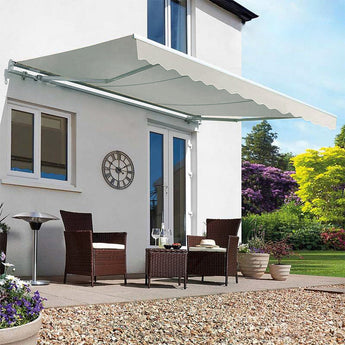 Grey manual retractable patio awning extended above outdoor seating area